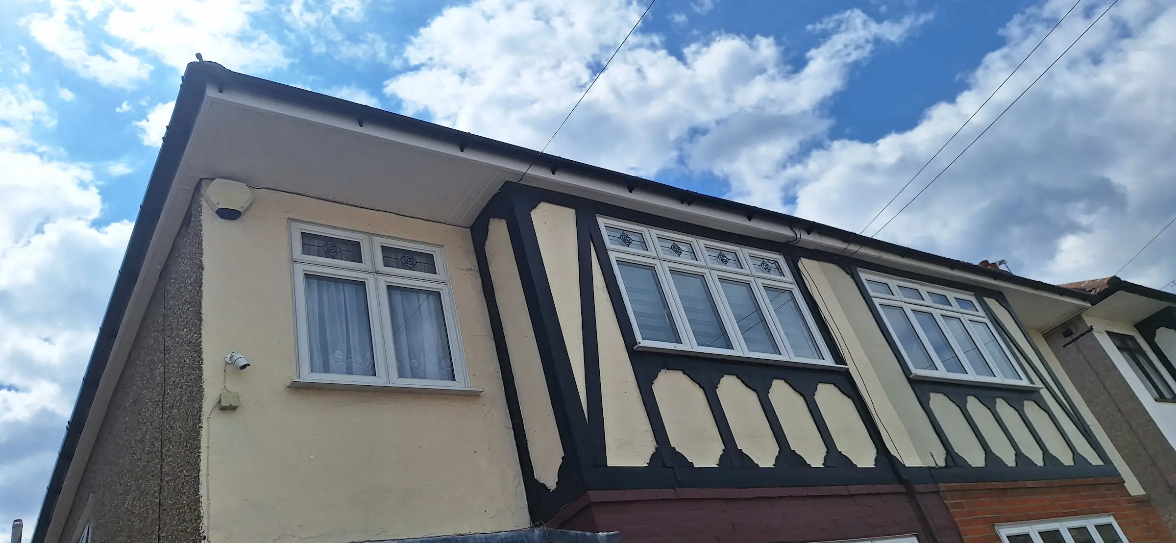 A building with two windows and a sky background